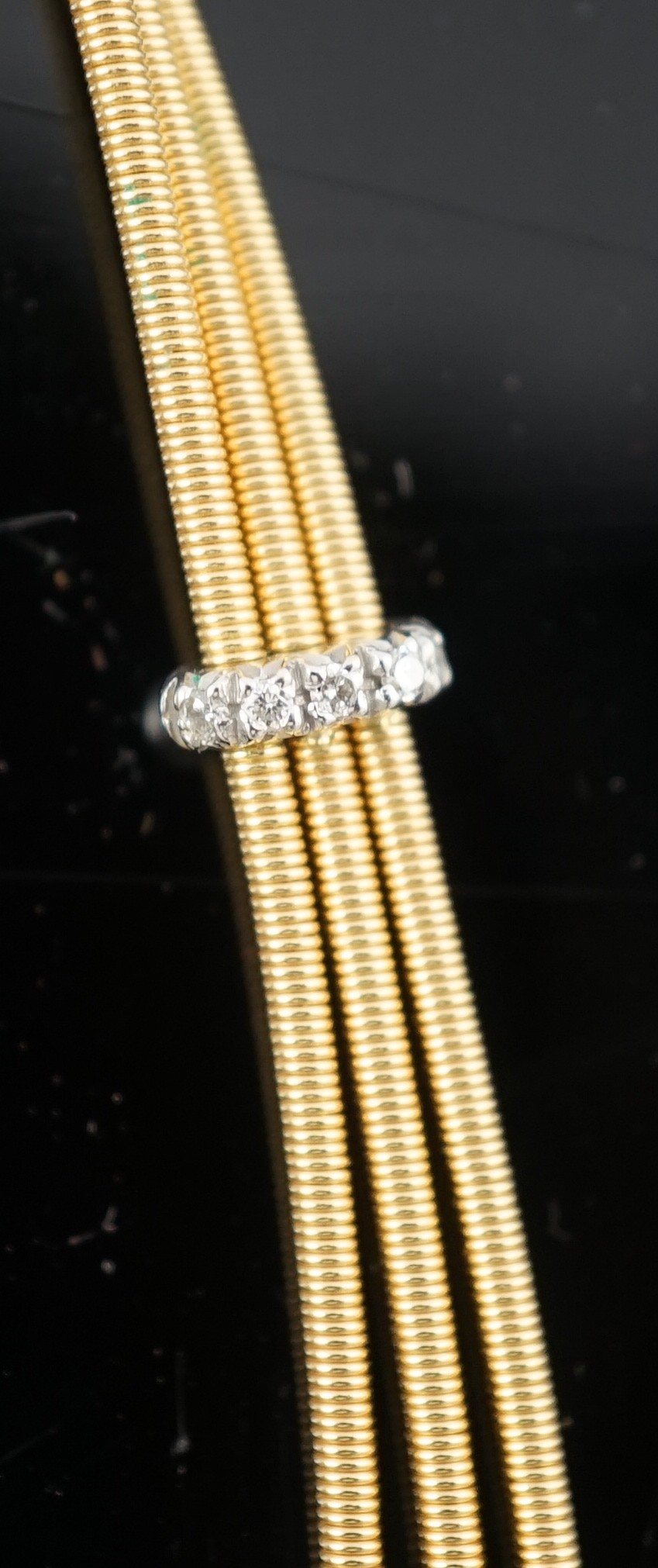 A modern Italian Marco Bicego 18ct gold and eleven stone diamond chip set triple strand necklace